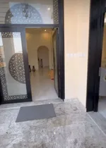 A new villa for sale in Sharjah, Al Hoshi area, consists of 5 master bedrooms, a hall, a majlis and a kitchen. There is an external extension with a kitchen, a maid's room, a laundry room, a pantry and an ironing room : Image 4