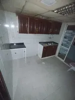 A happy room and a hall for annual rent in the Sanaiya area in Ajman, with multiple features such as a spacious hall, a modern design, 24-hour services and a vital area. We add central air conditioning, a kitchen with a balcony, and free parking, in  : Image 7