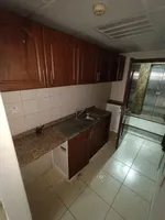 للايجار السسنوي استديو مساحه واسعه مطبخ منفصل خزائن في الحائط قريب من مخرج دبي والشارقه : Image 2