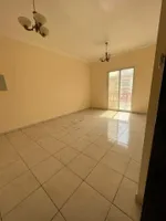 A spacious apartment with a balcony and a bathroom. The address is Al Nuaimah, close to King Faisal Street and Kuwait Street, Ali Mohammed bin Zayed Street, directly exit Dubai and Sharjah//Apartment with one bedroom, a living room, a balcony, and a  : Image 1