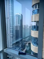 A great opportunity to live in Sharjah, Al Qasba area, Palm Tower 3, open view of Al Mamzar Lake with balcony, parking and closets in the wall, two rooms and a hall : Image 1