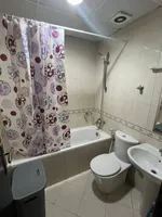 A room and a hall with a balcony, 2 bathrooms, City Tower, for annual rent in Ajman with furniture : Image 5