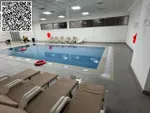 For annual rent in Ajman, a furnished room and hall with 2 bathrooms is available in Rashidiya 1 near Ghalfa Bridge and the Ambassador Market, with a balcony with an open view, a spacious area, central air conditioning with a gym and a free swimming  : Image 1