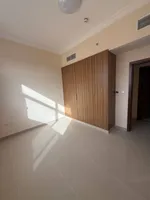 Two rooms and a hall for the first resident of Al Jerf 3 new tower for annual rent in Ajman with wall cabinets and a store : Image 4