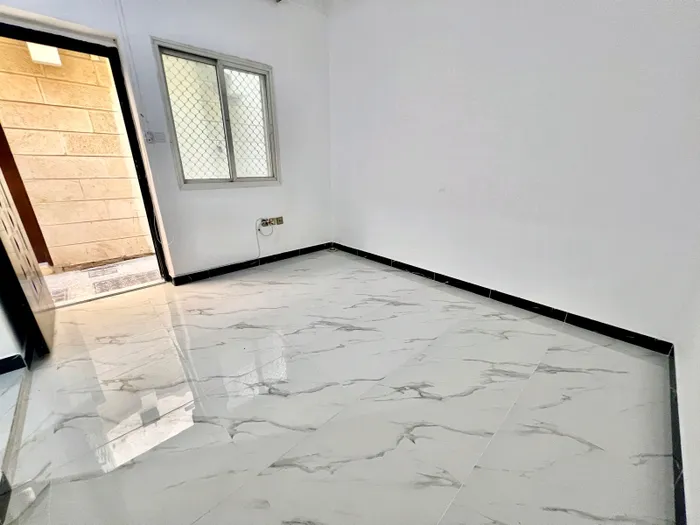 An apartment for rent in Mohammed Bin Zayed consists of a room, a hall and a bathroom : Image 1