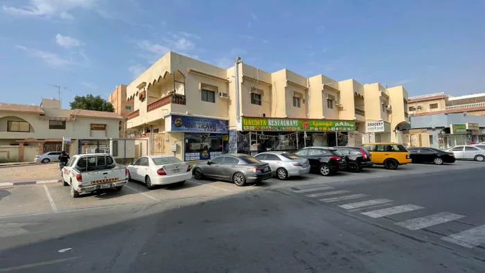For sale: a two-story building containing 2 studios, 8 apartments, and 5 shops. : Image 1