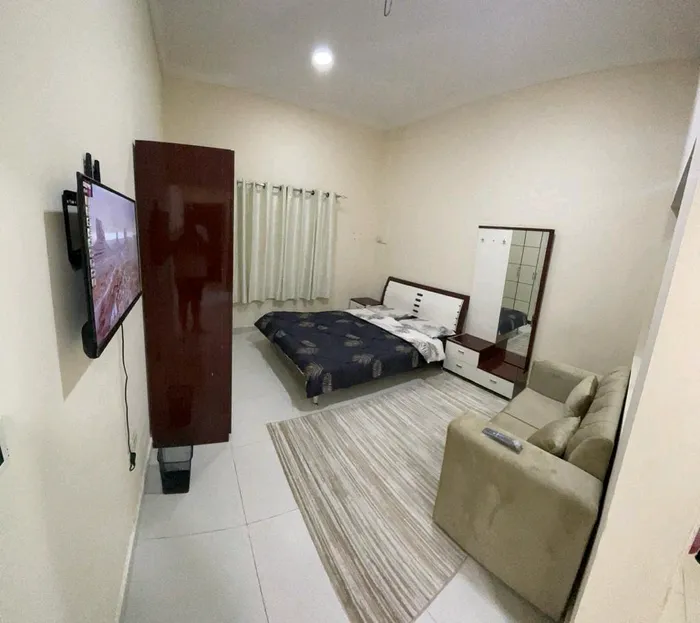 For rent a monthly furnished studio, separate kitchen, central air conditioning, in Ajman, Al Rawdah 2, Sheikh Ammar Street, easy exit to Dubai, including bills : Image 1