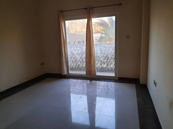 For annual rent in Al Nuaimiya 2, Ajman, a room and a balcony close to Al Safir Mall //For annual rent in Al Nuaimiya 2, Ajman One bedroom and a living room with a balcony, close to Al Safir Mall : Image 1