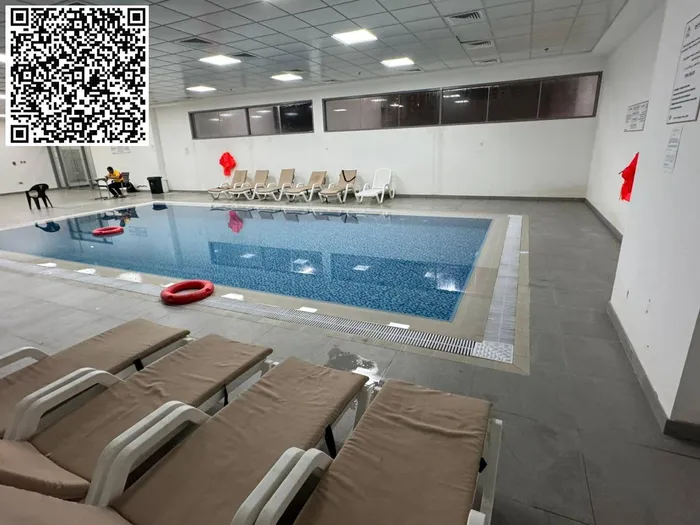 For annual rent in Ajman, a furnished room and hall with 2 bathrooms is available in Rashidiya 1 near Ghalfa Bridge and the Ambassador Market, with a balcony with an open view, a spacious area, central air conditioning with a gym and a free swimming  : Image 1